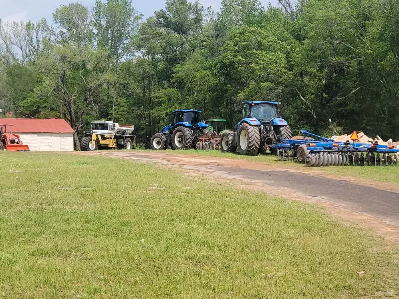 O-L Guy Farms tractors and field equipment lined up on the farm